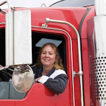 Female trucker in red semi-truck