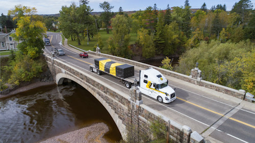 Halvor Lines flatbed truck crossing a bridge