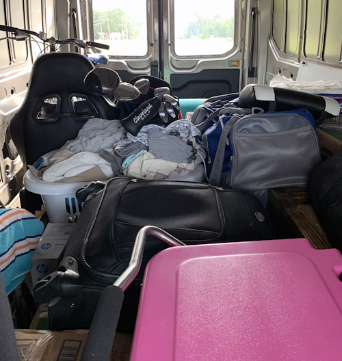 Inside 2020 Ford Transit 250 cargo van packed with belongings 